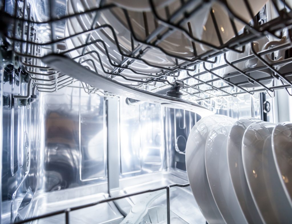 Interior of AEG dishwasher machine with clean dishes
