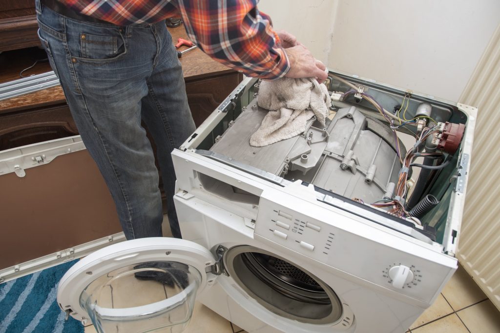 Handyman repairing washing machine in Joondalup
