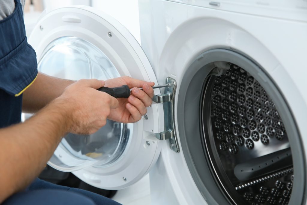 Hilton Appliance handyman fixing washing machine in Rockingham